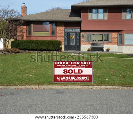 Real estate sold (another success let us help you buy sell your next home) sign Suburban high ranch house residential neighborhood USA