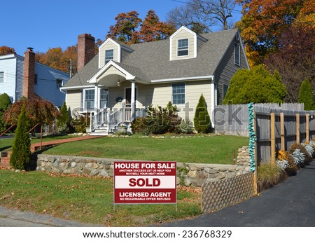 Real Estate sold (another success let us help you buy sell your next home) sign Suburban home autumn day residential neighborhood blue sky USA