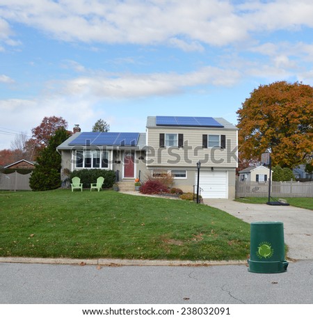 Recycle trash container curb side Suburban high ranch house autumn day residential neighborhood blue sky clouds USA