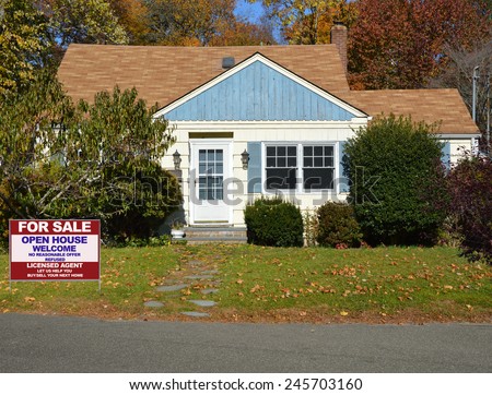Real estate for sale open house welcome sign on front yard lawn of Suburban home sunny autumn fall day residential neighborhood USA