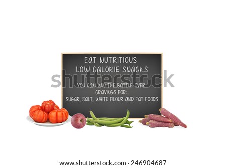 Eat Nutritious Low Calorie Snacks You can win the battle over cravings for sugar, salt, white flour and fat written on blackboard behind tomatoes, apple, fava beans and red carrots isolated on white