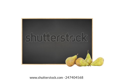Fresh Pears on table in front of blank chalkboard isolated on white background