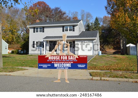 Real estate for sale open house welcome sign Suburban Gray High Ranch home autumn day residential neighborhood clear blue sky day USA