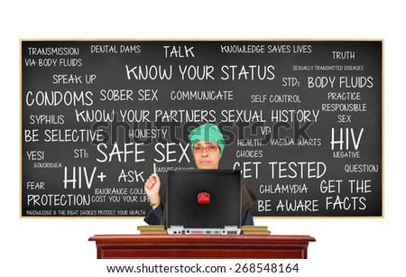 Teacher with Get Tested button on laptop pointing to Safe Sex Blackboard: Get Tested, Know Your Status, Get Facts, Protection, Question, Responsible Sex, Truth, Be Aware, Unsure Say No, Sober Sex