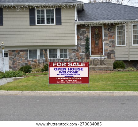 Close up of Real Estate for sale open house welcome sign high ranch style home residential neighborhood USA