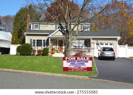 Real estate for sale open house welcome sign Suburban Cape Cod style home autumn clear blue sky day residential neighborhood USA
