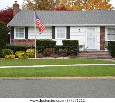 American Flag pole Close up of Ranch style Home Autumn Day Residential Neighborhood USA