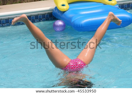 African American girl playing in pool