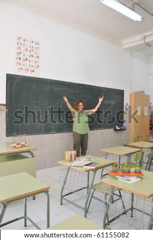 Elementary School Teacher in Spanish Classroom Waving