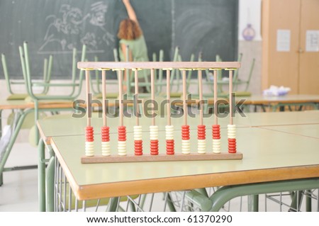Abacus on desk in Classroom Teacher in Background
