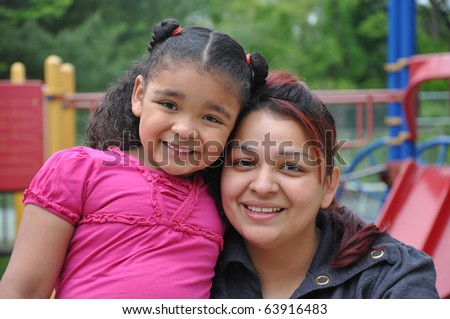 Single Parent Latin Family on Playground Closeup Tight Photograph