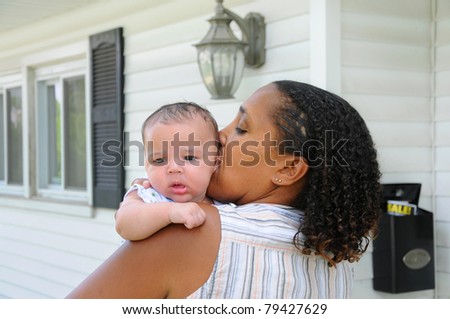 Two Generation Family Mature woman kissing Newborn Infant Baby Outside Home