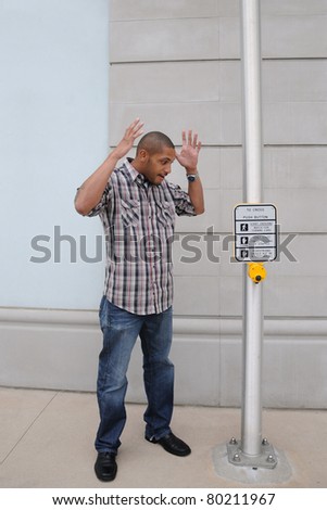 African American Man Arms Raised Shocked Facial Expression Street Crossing Light Pole