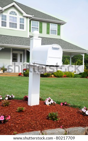 White Residential Mailbox on Suburban Front Lawn