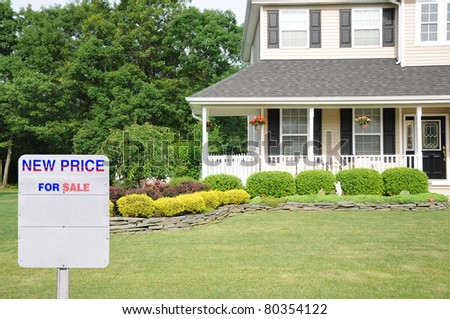 For Sale Sign on Lawn of Manicure Landscaped Suburban Residential House