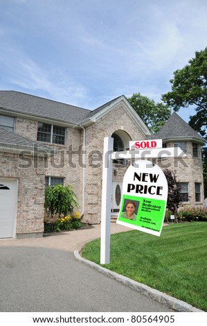 Realtor Real Estate Sold For Sale Sign Post in front of Luxury Suburban Home