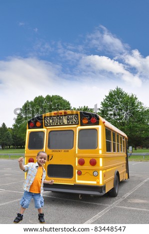 Happy Little Boy in Front of Yellow School Bus on Cloudy Blue Sky Day
