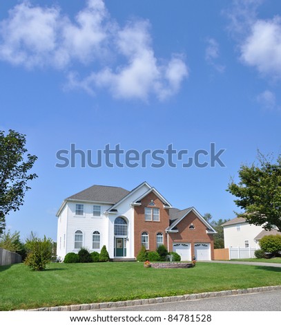 Suburban Luxury Two Story Two Car Garage Home Sunny Blue Sky Day