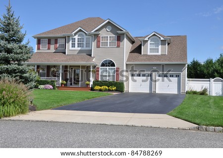 Large Two Story Two Car Garage Suburban Home Driveway Landscaped Front Yard