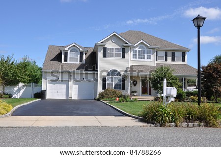 Suburban Luxury Two Story Two Car Garage Home Driveway Landscaped Front Yard Mailbox Street Light Lamp post
