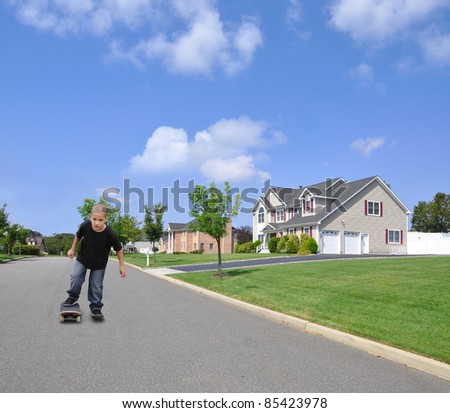 Little Kindergarten Age Boy on Skateboard on Street in Suburban Residential District under Beautiful Blue Sky