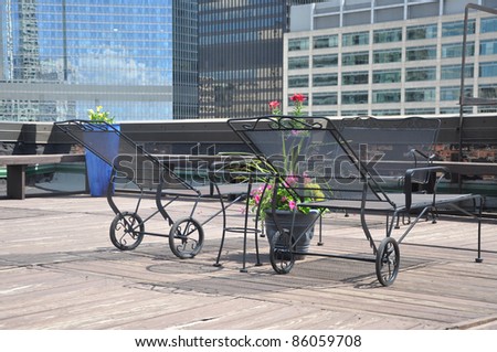 Iron Lounge Chairs on Outdoor Rooftop Deck in Urban City