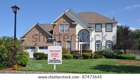 Realtor Short Sale For Sale Sign on Landscaped Front Yard Lawn in Residential District on Blue Sky Sunny Day