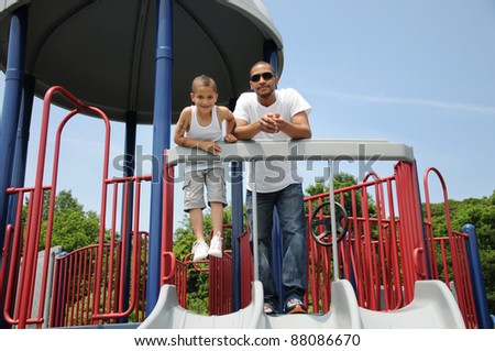 Father and Son on Playground Equipment Two Generation Family
