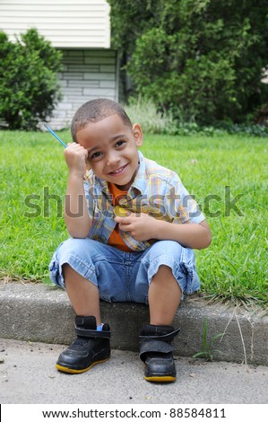 Handsome Preschool Age Little Boy Sitting on Lawn Curb Leaning his Head on his Hand