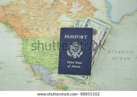 Blue American Passport filled with U. S. Currency on Map Background United States of America