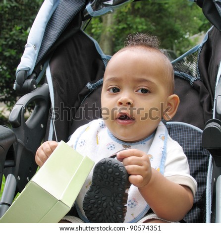 Baby Boy with Mohawk Hairstyle holding shoe and box