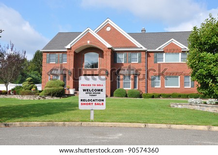 Real Estate Welcome Open House Relocation For Sale Sign on front yard lawn of suburban brick home on blue sky day
