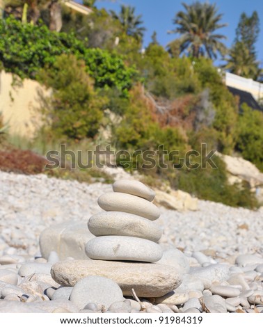 Meditation Stone Tower (Zen like) on rocky ground with nature in the background