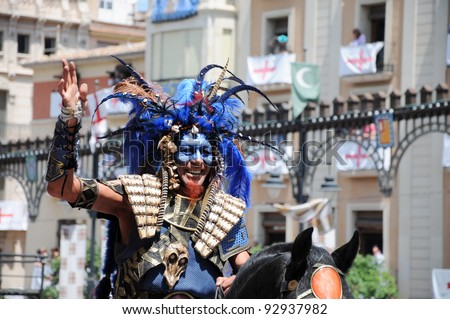 ALCOY, SPAIN - MAY 14: Man waving riiding horse in annual parade commerating past battles between Moors and Christians during the period known as Reconquista (8th - 15th century) .Alcoy May 14, 2011
