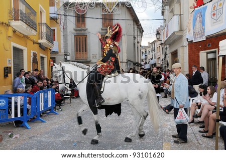 MURO ALCOY, SPAIN - MAY 7: Man dressed in Moor costume on horse marching and performing for spectators at annual Moros y Cristianos parade commemorating 15th century battles in Muro Alcoy May 7, 2011.