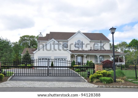 Suburban Home with Black Rod Iron Fence in Residential District Neighborhood