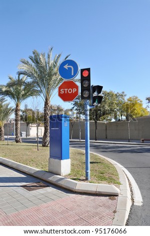 Curb Red Traffic Light Green Pedestrian Light Stop Sign Blue Arrow under Clear Blue Sky