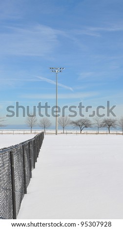 Snow covered empty baseball field in Chicago Illinois Lake Michigan Beachfront Park