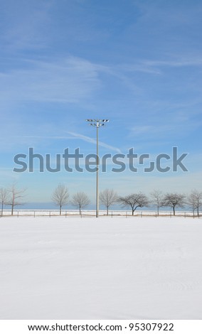 Snow covered empty baseball field in Chicago Illinois Lake Michigan Beachfront Park