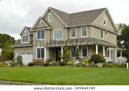 Suburban McMansion style home overcast cloudy day residential neighborhood USA