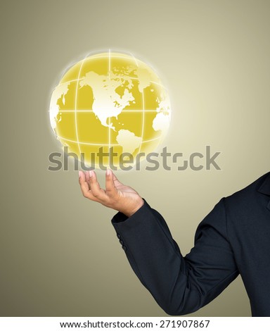 Businessman holds earth in a hand gold background