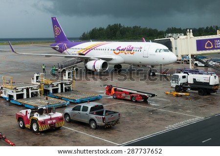 Phuket, Thailand - June 15, 2015: Thai Smiles Airways\'s airplane standby at the airport before taking off on a bad weather in monsoon season
