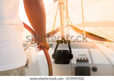 Main sailing luxury yacht during golden sunset in Phuket, Thailand