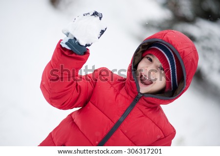 Boy with red jacket in winter