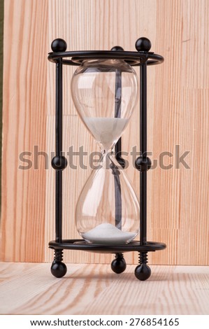 sand watch isolated on wooden background