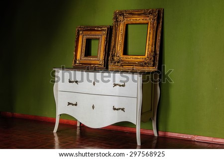 frames on a chest of drawers