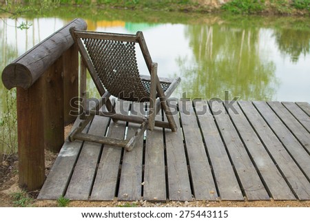 hammock chair stands on a pier on the lake