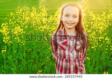 little girl in the field with flowers. portrait