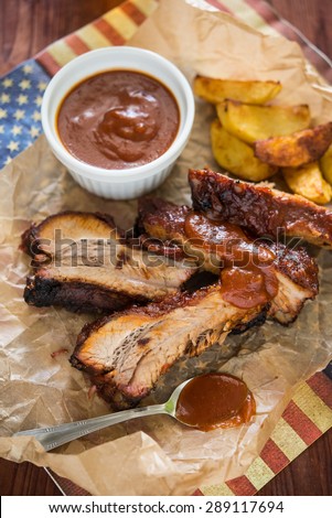 Baked ribs with BBQ sauce with potato wedges