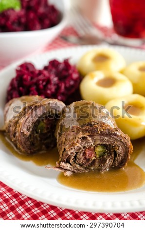 Beef rolls stuffed with bacon and pickle, potato dumplings and fried beetroots, typical polish dinner